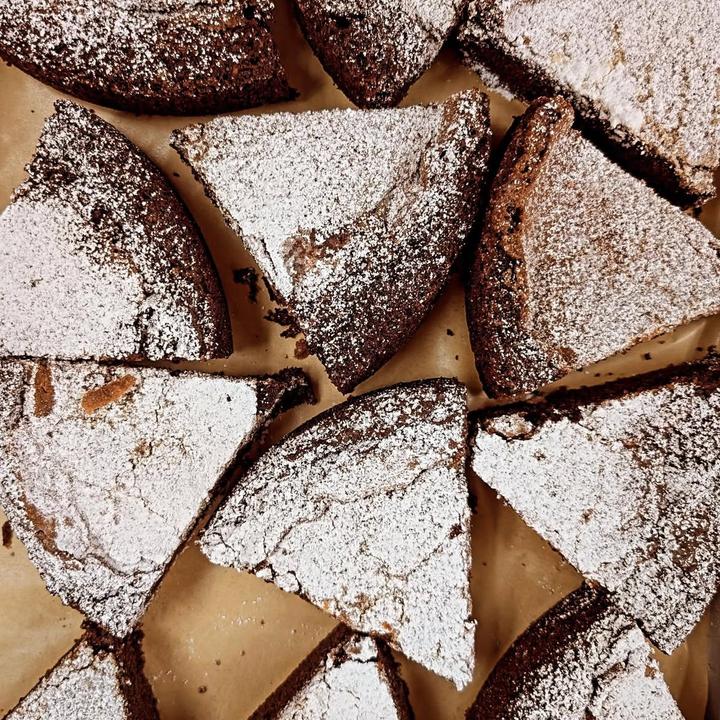Slices of chocolate cake dusted with sugar